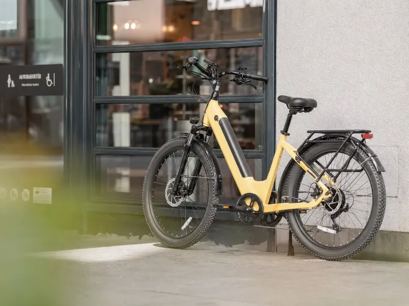 Yellow city electric bike parked outside a storefront