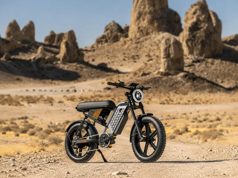 Fat-tire electric bike on a desert dirt road in front of sandstone rock formations